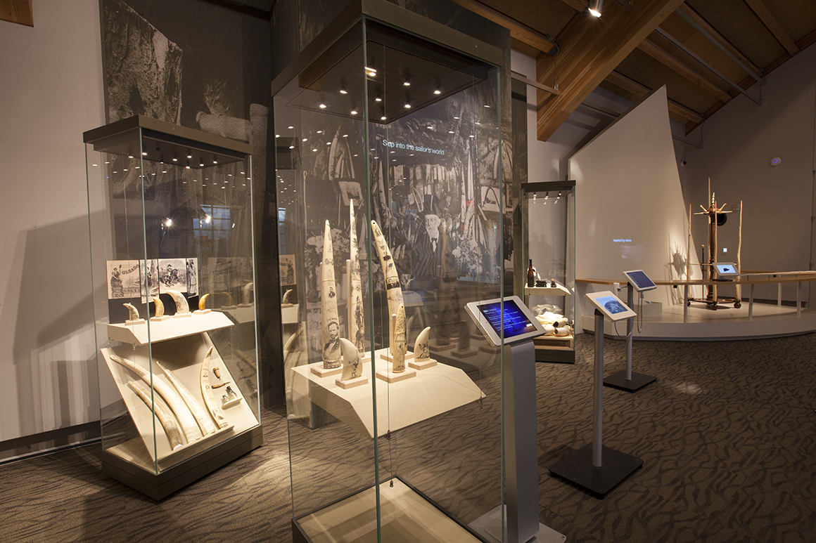 In this section of exhibit, a mural of the 1850 Cobweb Palace saloon with interactive displays inform guests about how scrimshaw is created. 
