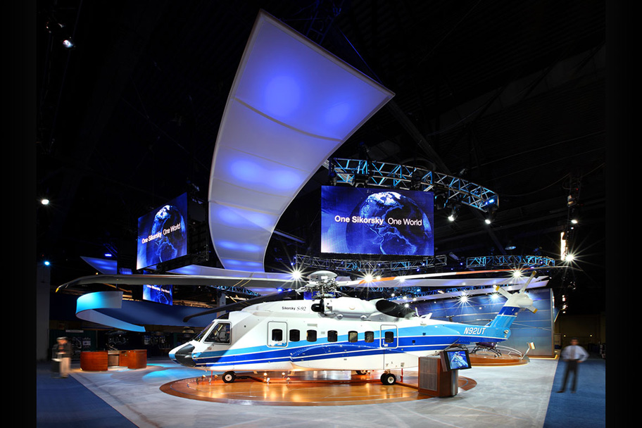 The S-92 helicopter display is supported by large overhead screens showing high energy media.